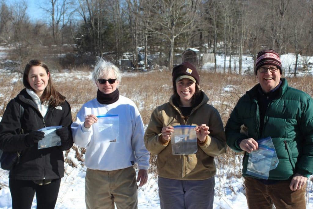 Volunteers happily showing off their poop.